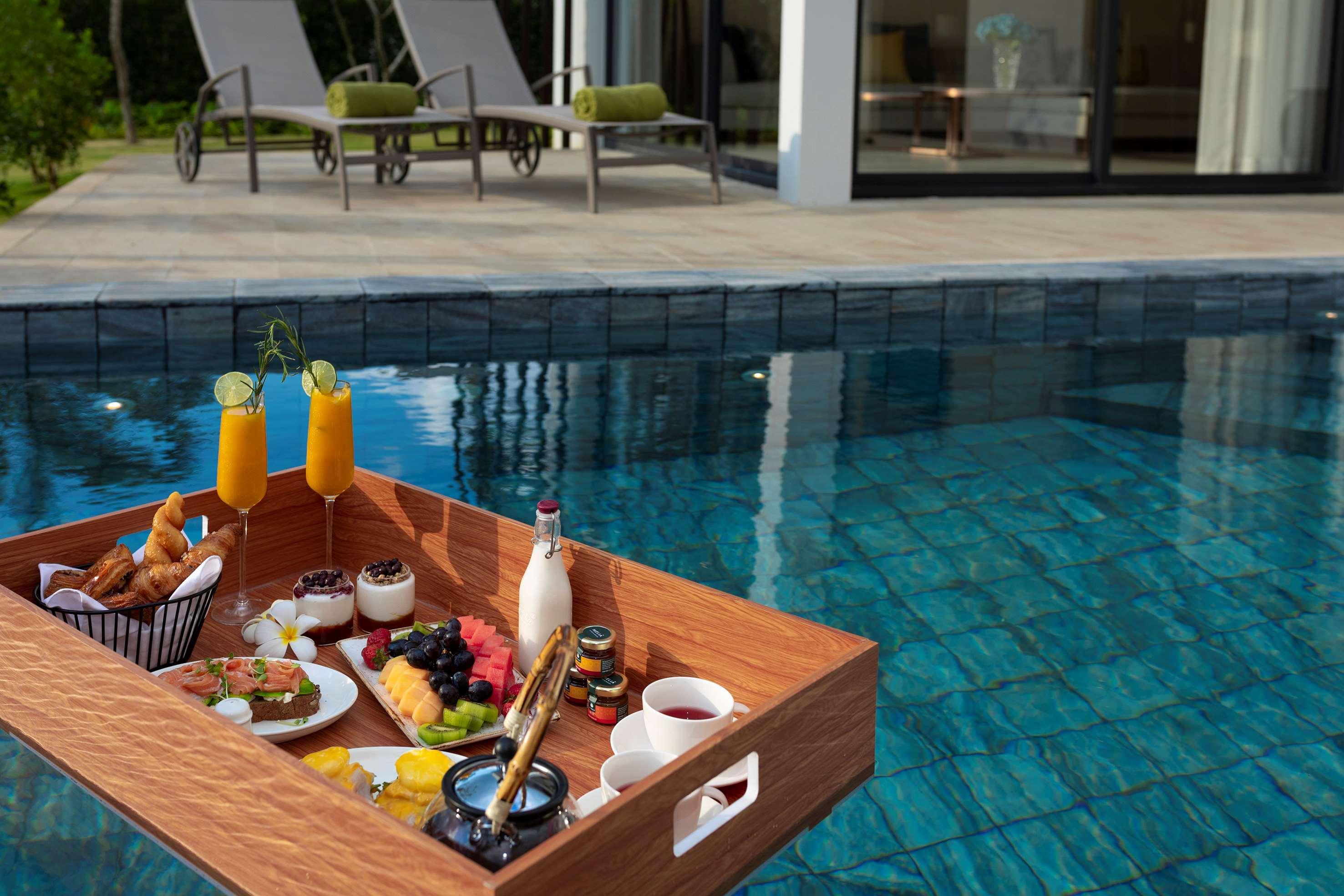 Melia Ho Tram Beach Resort Bagian luar foto Floating breakfast at a resort in Phuket, Thailand